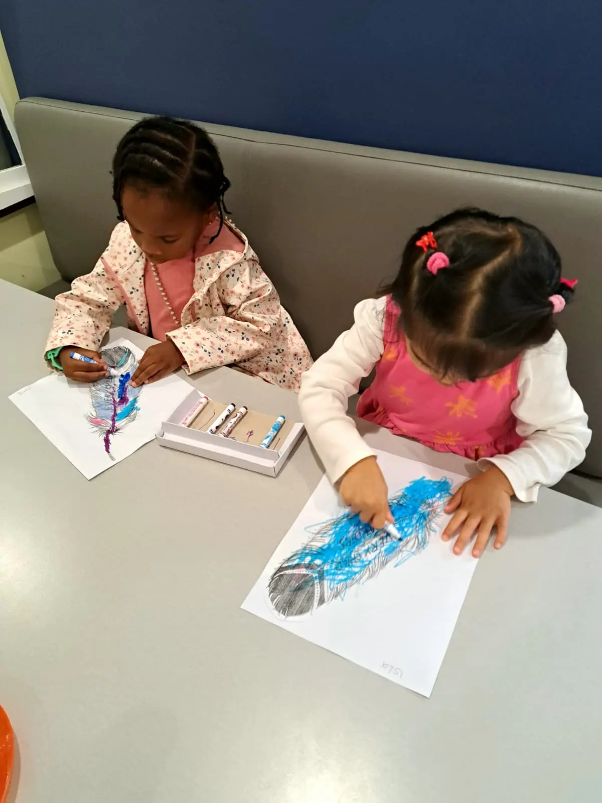 Children creating colorful feather art together