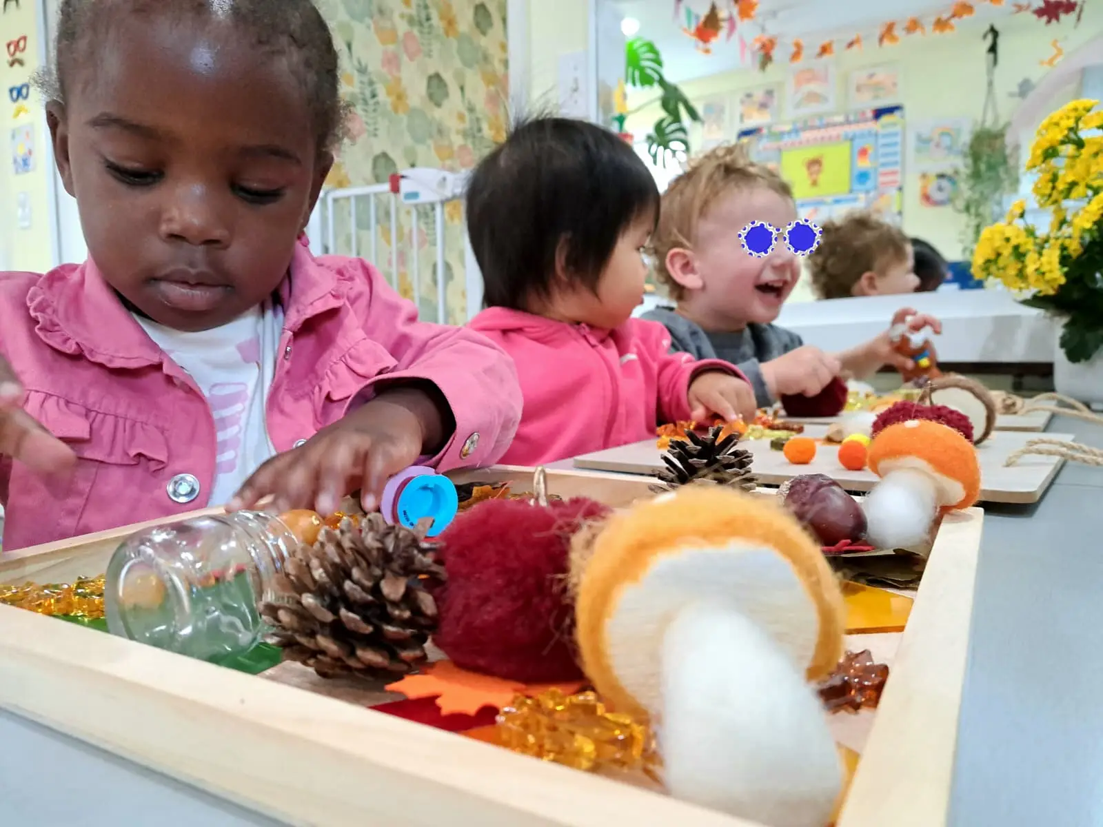 Children engaged in sensory play with natural materials